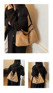 Detail view of khaki tote bag with black leather straps and versatile carrying styles