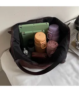 Interior view of large brown tote bag showing spacious capacity for tablets and bottles