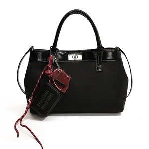 Minimalist black PU crossbody bag with matte finish and silver twist-lock closure