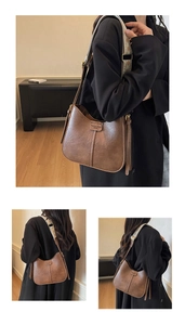 Detail of brown hobo bag with geometric strap and Fashion Trend embossed texture