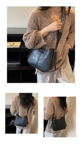 Detail of black PU leather crossbody bag with geometric woven strap and metallic buckle