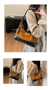 Detail of retro quilted brown suede underarm bag with gold twist lock and wooden beads