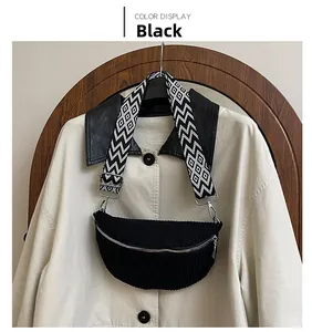 Detail of black corduroy waist bag with geometric pattern wide strap on trench coat