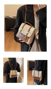 Detail of color-block vintage bag showing the top handle and adjustable shoulder straps