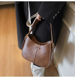 Close-up of vintage brown leather hobo bag with Fashion trend VIVIU label detail