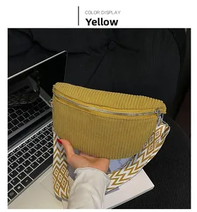 Detail of yellow corduroy crescent waist bag with geometric patterned woven strap