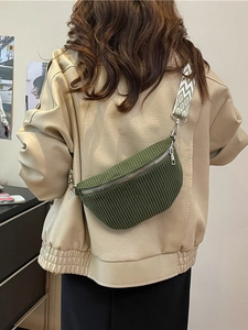 Dark green corduroy waist bag for women with geometric jacquard strap on a model