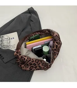 Detailed view of the spacious interior of a leopard print tote bag with daily essentials