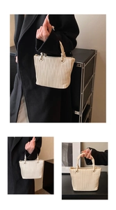 Detail of beige pleated bucket bag featuring matte synthetic leather and vertical folds