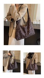 Detail view of large leopard print hobo bag with black leather strap for autumn style