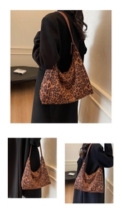 Detail view of large leopard print tote bag with brown straps in a lifestyle setting