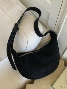 Retro black faux suede half-moon dumpling bag with adjustable shoulder strap and metal zipper