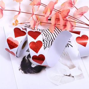 Roll of red laser glitter heart-shaped stickers for gift wrapping and holiday decor