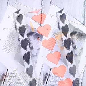 Roll of coral heart-shaped thank you stickers for festive gift packaging and decoration