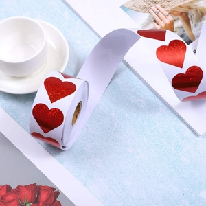 Macro view of red laser heart stickers roll for gift wrapping and festive decoration