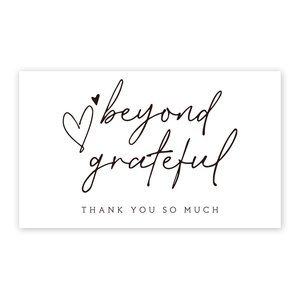 Close-up of minimalist thank you card with beyond grateful lettering and a heart