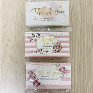 Close-up of three business thank you cards with floral, marble, and stripe patterns