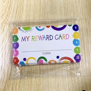 Close-up of 50 student reward cards on wood surface showing 1-10 progress tracking circles