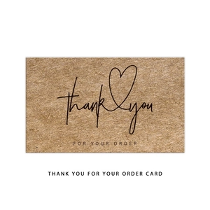 Detail of brown kraft paper thank you card with heart motif and elegant black lettering
