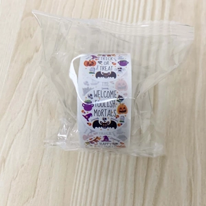 Detailed view of Halloween pumpkin and witch roll stickers in clear packaging