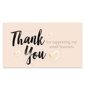Detail of pink small business thank you card with gold hearts and cursive text