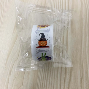 Roll of Halloween stickers in plastic packaging featuring spooky pumpkin and zombie hand designs