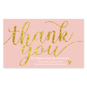 Close-up of pink business thank you card with gold glitter text for order packaging