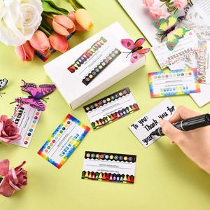 Macro view of loyalty punch cards with floral designs and decorative gift box