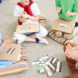 Group of children using colorful rainbow themed reward punch cards on a light grey rug