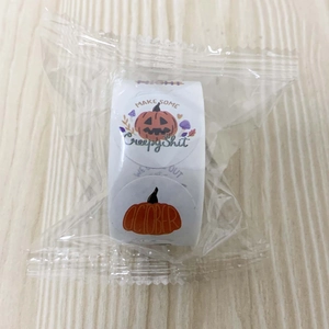 Close-up of Halloween roll stickers featuring pumpkin patterns on a light wooden background