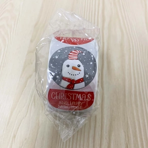 Detail of Christmas roll stickers featuring snowman illustration in clear plastic packaging