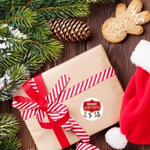 Merry Christmas kraft paper roll stickers on a gift box with festive pine and ornaments