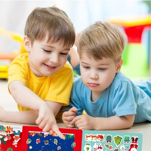 Kids playing with Christmas DIY sticker sheets featuring Santa, trees and reindeer