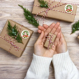 Merry Christmas kraft paper roll stickers featuring wreaths and gift box designs on wood