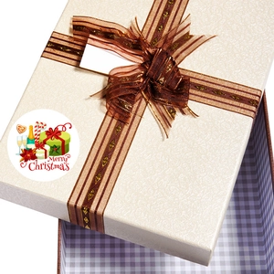 Roll of Merry Christmas stickers with festive patterns on a decorative gift box