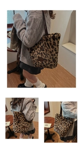 Detailed close-up of large leopard print plush tote bag with soft faux fur and leather patch