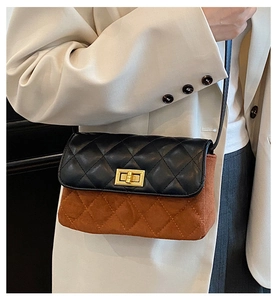 Detail of rhombic quilted crossbody bag with golden twist lock and bicolor texture