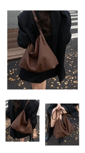 Detail of soft brown lychee grain leather tote bag with adjustable shoulder strap