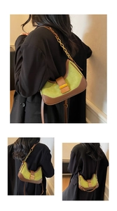 Detail view of avocado green contrast shoulder bag with golden chain and retro metal clasp