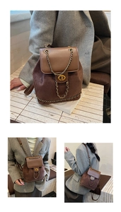 Detail of vintage brown suede leather backpack featuring a golden twist lock and chain strap