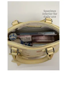 Top view of cream shell bag interior showing large capacity for phone and cosmetics