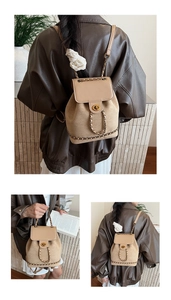 Detailed view of khaki suede bucket backpack with golden chain strap and twist lock