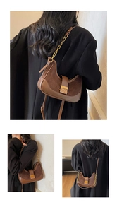 Detail of vintage brown crossbody bag featuring mixed textures and a gold chain strap