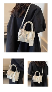Detail of white lychee texture bucket bag with silk scarf and silver metal buckle hardware