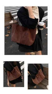 Detail view of large dark brown suede tote bag in a stylish autumn street scene
