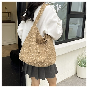 Detail of the light brown fuzzy tote bag with textured fleece material in a street style