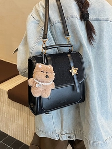 Chic black quilted backpack for women with star buckle and plush bear pendant