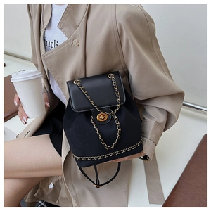 Detail of black drawstring bucket backpack with chain strap and gold twist lock closure