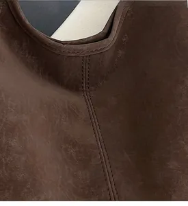 Detail of dark brown leather tote bag showing high-quality double stitching and texture