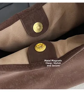 Macro shot of durable gold magnetic snap closure and brown leather trim on tote bag